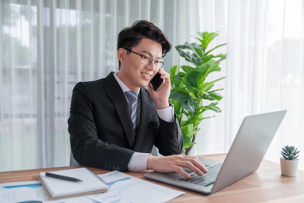 Businessman working on laptop for on office desk workspace Jubilant