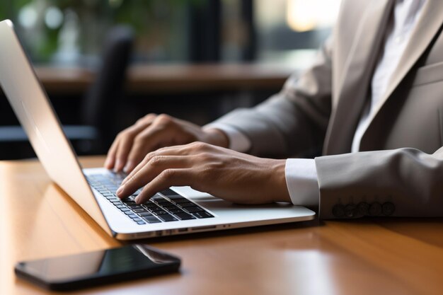 Businessman working on laptop in the office at sunset Close up