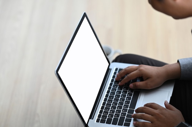 Businessman working on laptop and sitting on floor