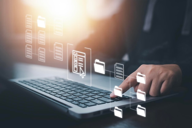 仮想画面を備えたラップトップで作業するビジネスマンオンライン文書データベースITコンサルタントがセットアップされているラップトップを使用した仮想文書管理システム企業ファイルをアーカイブするためのソフトウェア