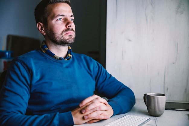 A businessman working late in his home office