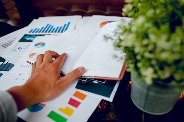 Businessman working at the office And graphs on his desk. Business concept And copy space