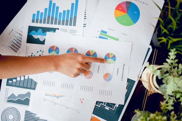 Businessman working at the office. And graphs on his desk. Business ideas and space for copy.