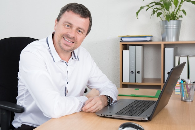 Businessman working in office, sitting at desk