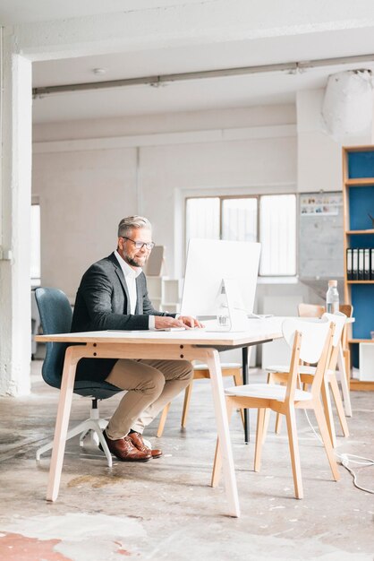 Businessman working in office using computer