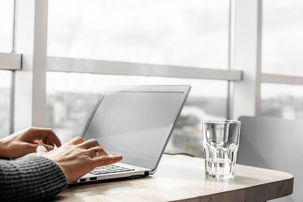 A businessman working in an office with large windows.