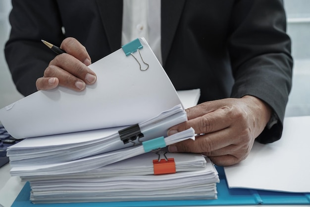 Businessman working and prepare paperwork report data to analysis information in file binder at office