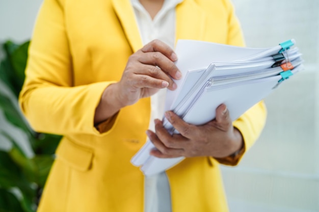 Businessman working and prepare paperwork report data to analysis information in file binder at office