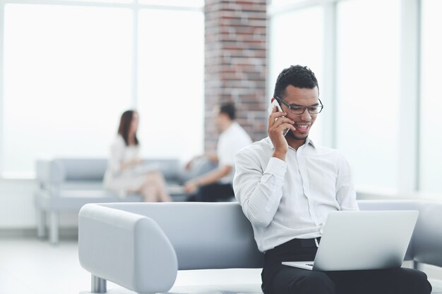 Businessman working sitting in the lobby of a modern office.people and technology