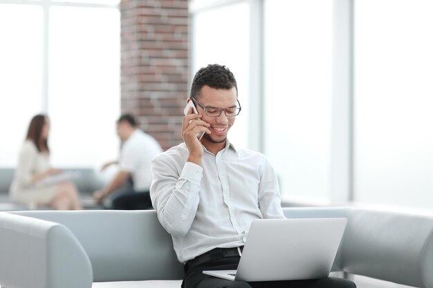 Businessman working sitting in the lobby of a modern office