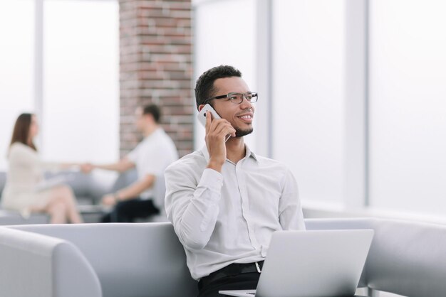 Businessman working sitting in the lobby of a modern office