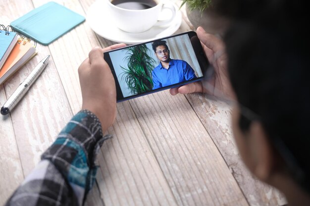 Businessman working in video conference close up