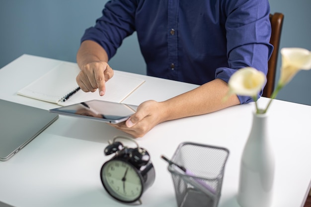 businessman working on white desk with laptop pad smartphone at office work from home concepts