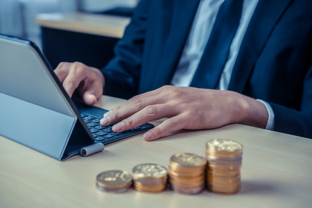 Businessman working with coin money currency.