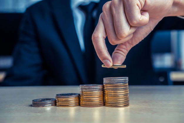 Businessman working with coin money currency.