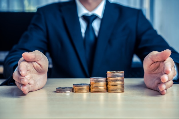 Businessman working with coin money currency.