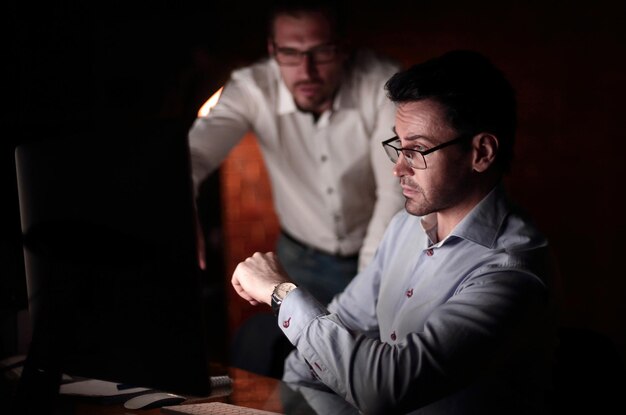 Businessman working with documents dark office