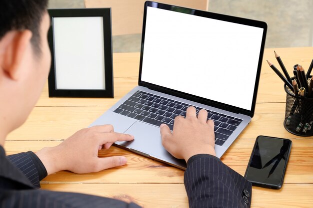 Businessman working with mockup laptop.