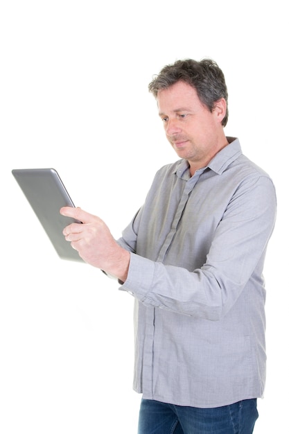 Businessman working with tablet pc on white wall