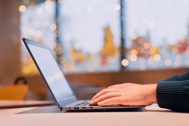 Businessman works at a laptop in a cafe