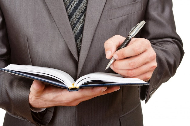 Businessman writing in business diary