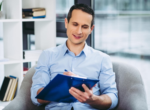 Businessman writing on the clipboard