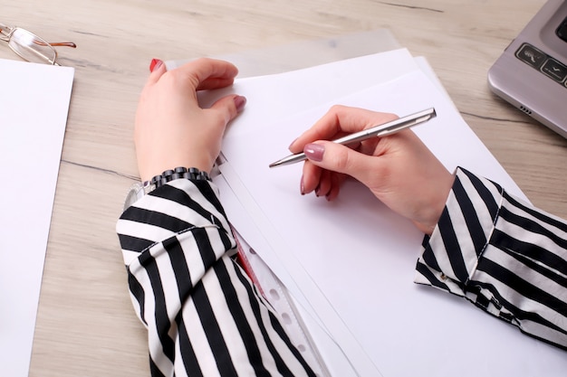 Businessman writing or drawing a note in a blank notebook