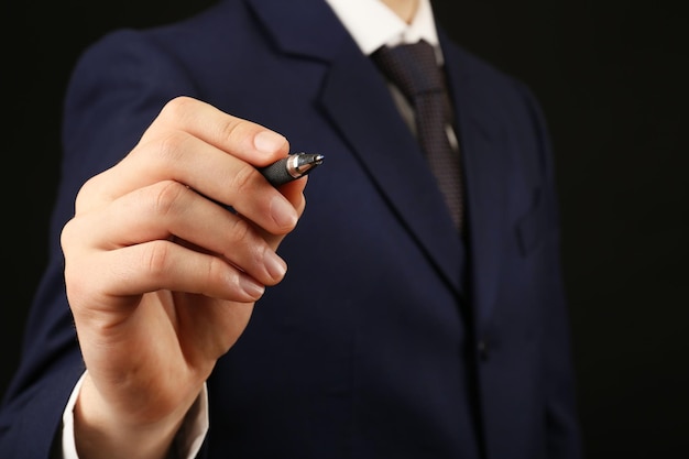 Businessman writing on screen closeup