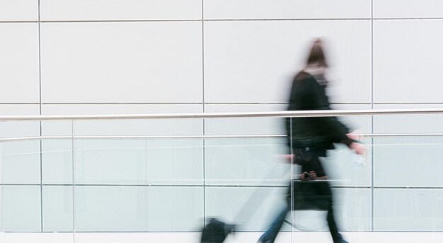 businessmann walking in a modern floor at a airport, including copy space. ideal for websites and magazines layouts