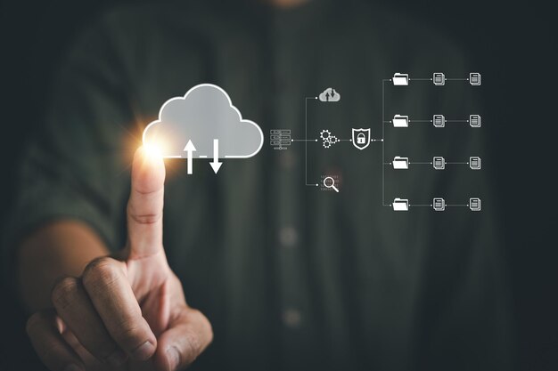 The businessmans finger points to the cloud icon signifying the seamless connection and access to da