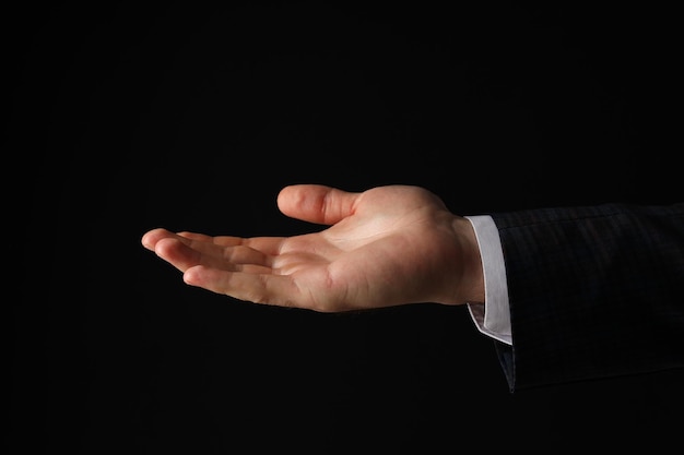 businessmans hand closeup on a black background