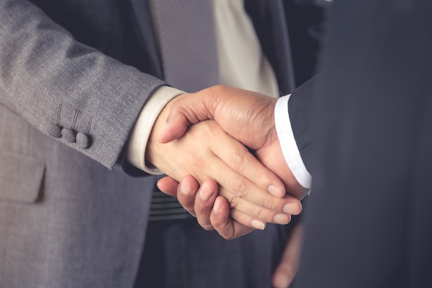 businessmen are handshake agree to join the business