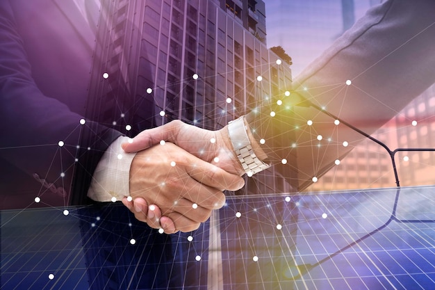 Businessmen are shaking hands for business venture and Marketing on energySolar is needed in the futureSolar panels require expertise in installationphotovoltaics to the business sector