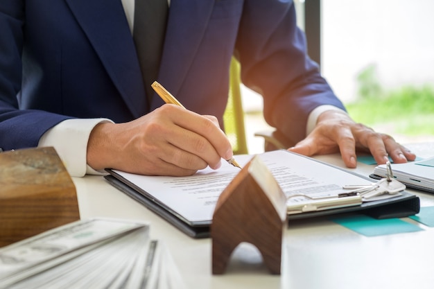 Businessmen are signing a house purchase contract