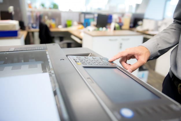 Businessmen are using photocopier.