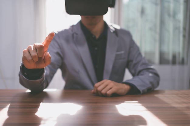 Businessmen are using virtual reality glasses in the virtual metaverse world.