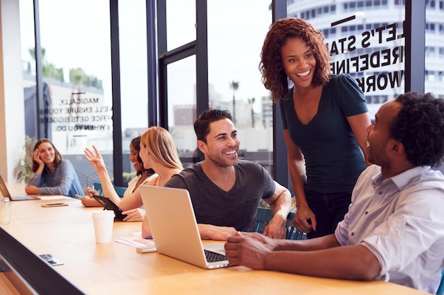 Businessmen And Businesswomen Working In Shared Open Plan Office Workspace