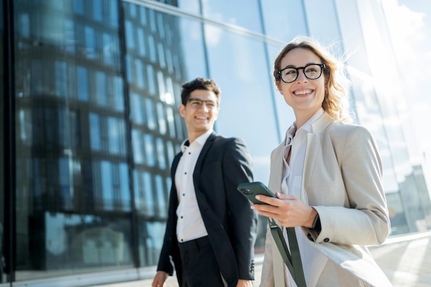 Businessmen colleagues team a woman and a man in business suits\
go to the office