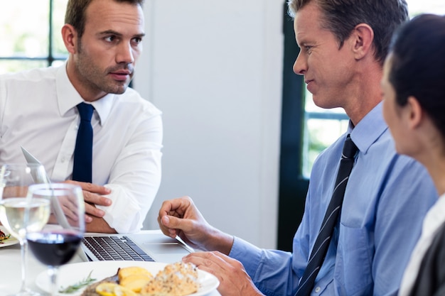 Businessmen discussing during a business lunch meeting