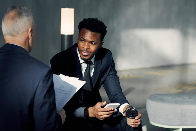 Businessmen discussing data in hall