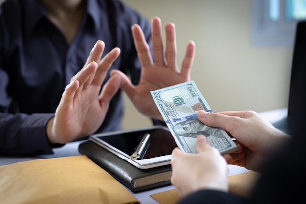 Photo businessmen give dollars to bribe employees in signing contracts to buy illegal land and real estate