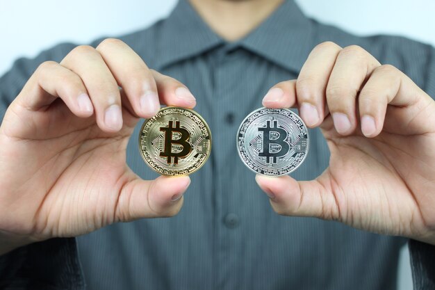 Businessmen hold Gold and silver currency of bitcoin.