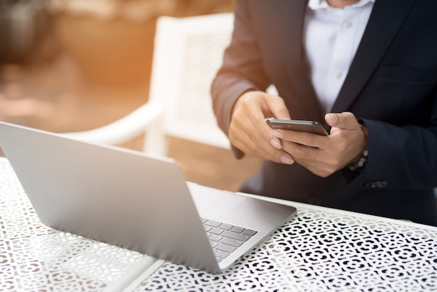 Businessmen hold the phone to check email on the internet.