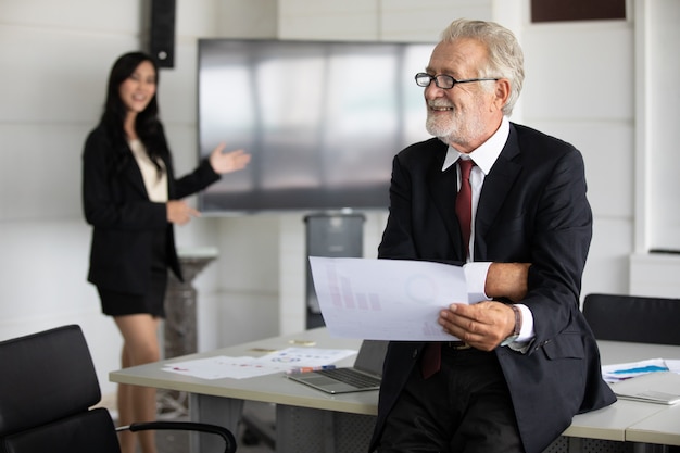 Businessmen holding documents for business partners discussing 