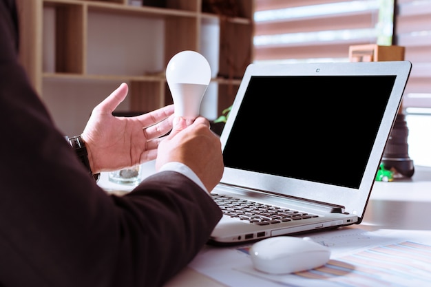 Businessmen holding light bulb as a creative model