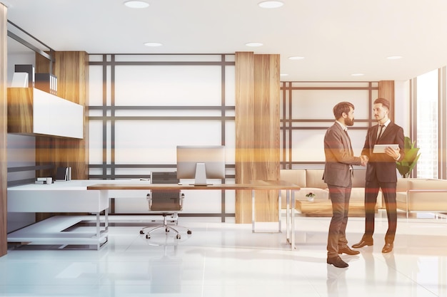 Businessmen in interior of manager office with white striped walls, tiled floor, white and wooden computer table, white shelves and lounge area with sofa and armchair. Toned image