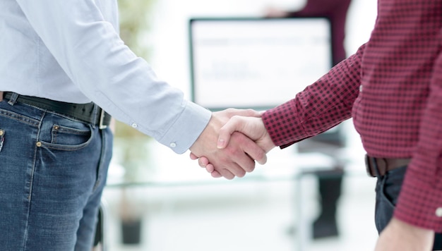 Businessmen making handshake in an office