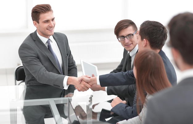 Businessmen making handshake in an office