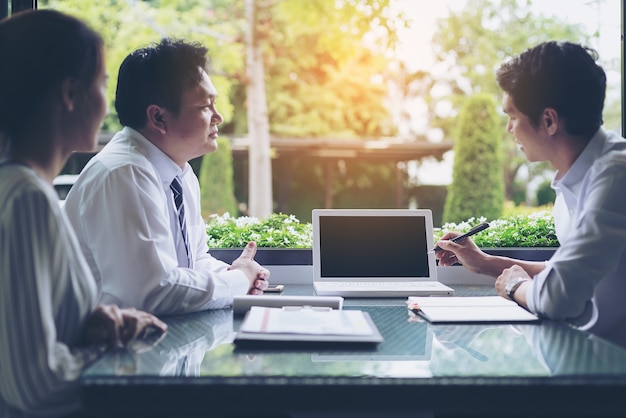 Businessmen negotiate terms and conditions before signing a business co-operation agreement