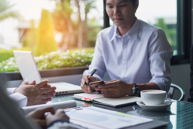 Businessmen negotiate terms and conditions before signing a business co-operation agreement